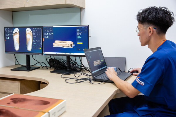 A podiatrist demonstrating how custom insoles are designed in Sengkang General Hospital.