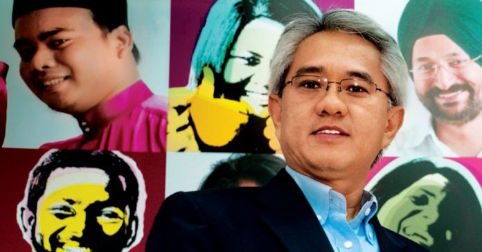 jamaludin ibrahim Jamaludin Ibrahim poses for the camera in front of a diverse collage of people.