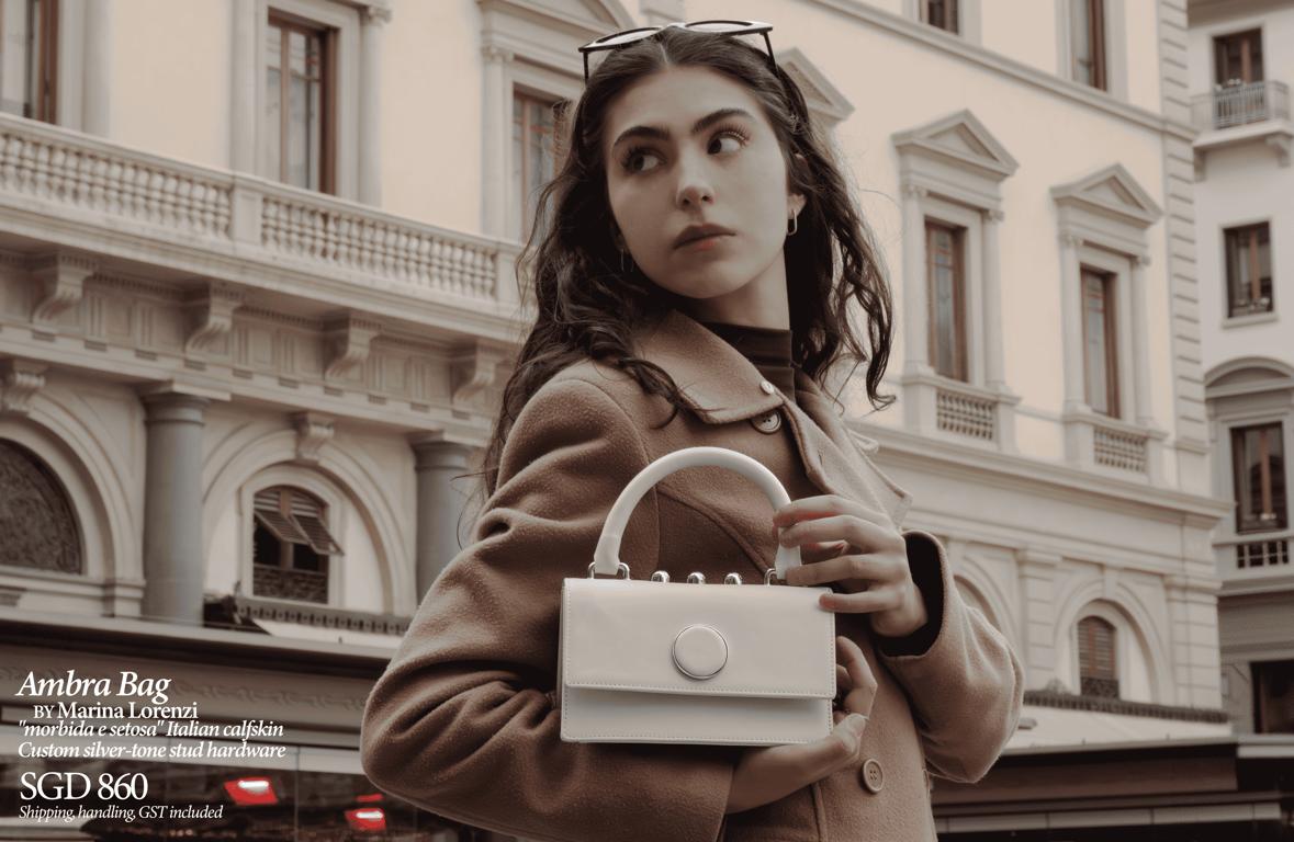 <i>The Ambra Bag, Marina Lorenzi. S$860, GST included.</i>“><figcaption><i>The Ambra Bag, Marina Lorenzi. S$860, GST included.</i></figcaption></figure>
<h2>
Curated European Luxury, 100% Made in<br />
Italy<br />
</h2>
<p>Each piece is crafted by Italian artisans, using<br />
LWG-certified Italian calfskin sourced from the Veneto region and 18K<br />
gold-plated hardware from specialized Italian workshops, with<br />
production in Florence, the heart of Italian leatherworking. Every<br />
handbag is guaranteed 100% Made in Italy with a Certificate of<br />
Origin, combining heritage techniques with contemporary<br />
design.
</p>
<figure> <img decoding=