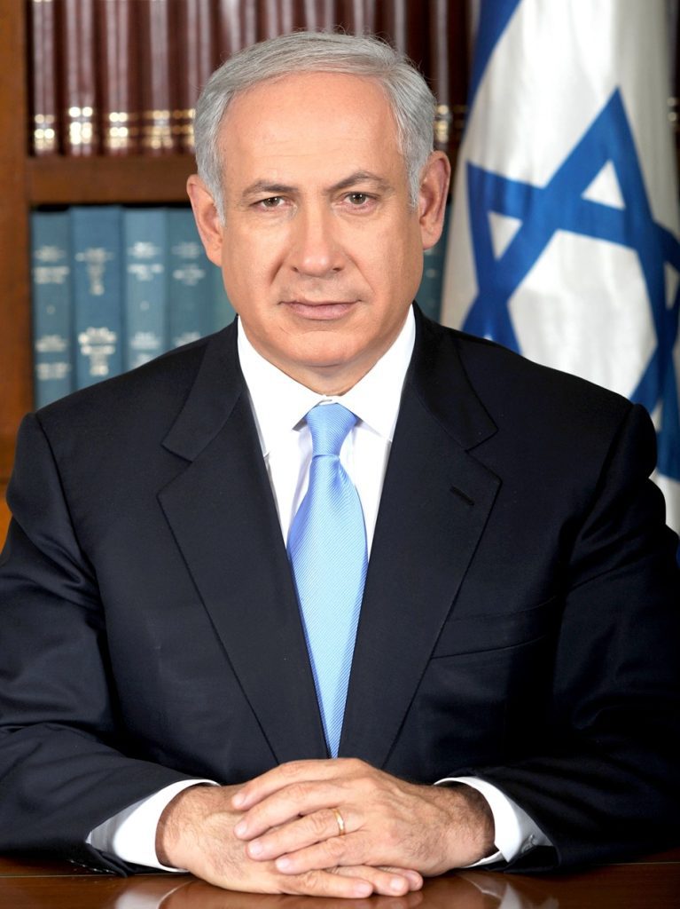 a photo of benjamin netanyahu, the current prime minister of israel seated at his desk