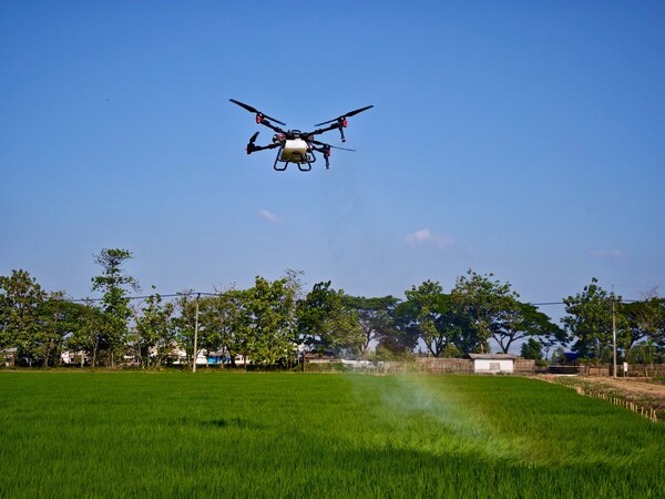 The XAG P100 Pro agricultural drone sprays over lush rice paddies managed by SHS Sukamandi.