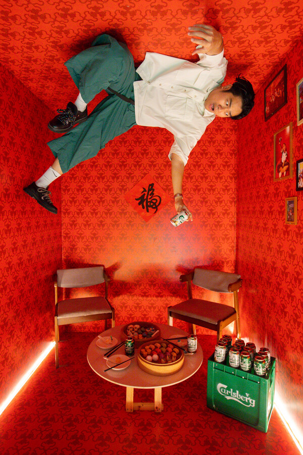 Guests enjoying the photo installation featuring an upside down room.