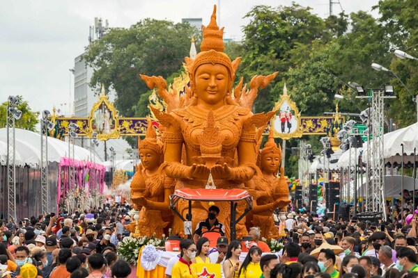A monumental carved-wax sculpture moves through Ubon Ratchathani during the annual Candle Procession, whose enduring cultural significance has prompted TAT to designate it a Signature Thailand Event.